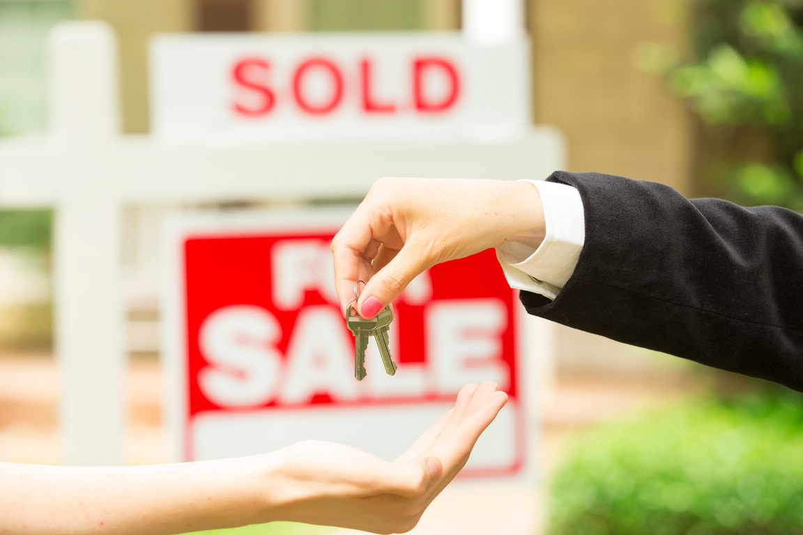House for sale sign. Realtor gives buyer keys. Home.  Sold.